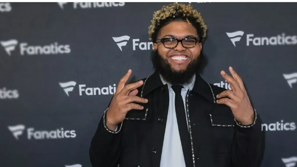 Comedian Druski smiling broadly on stage at the 2026 BET Awards at the Peacock Theater