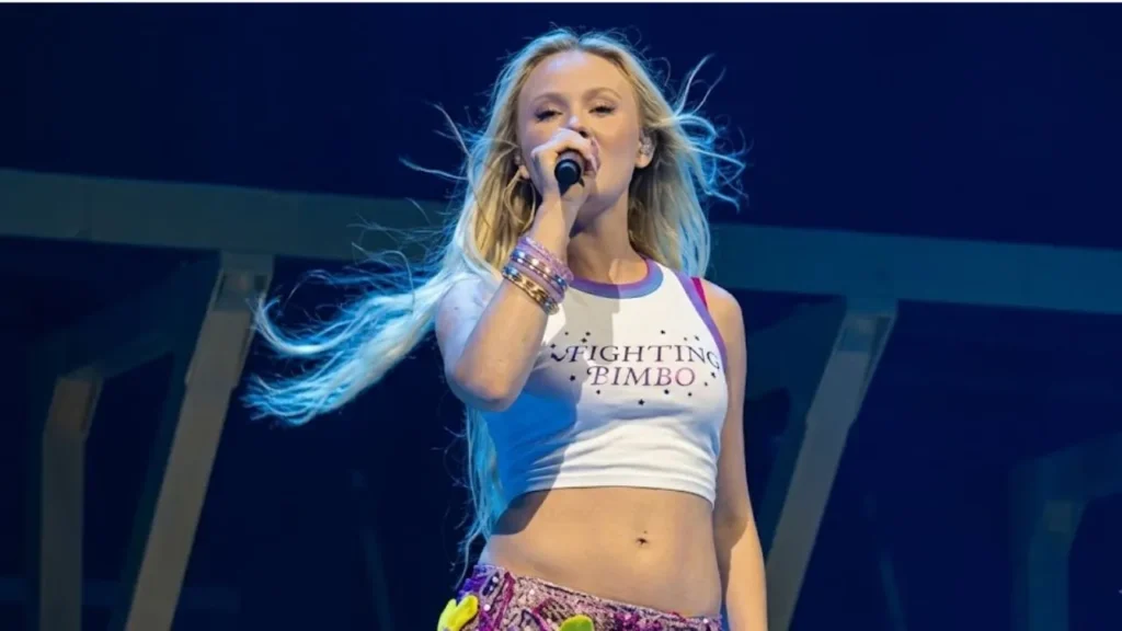 Zara Larsson performing live on her spectacular Midnight Sun Tour stage under bright arena production lights.