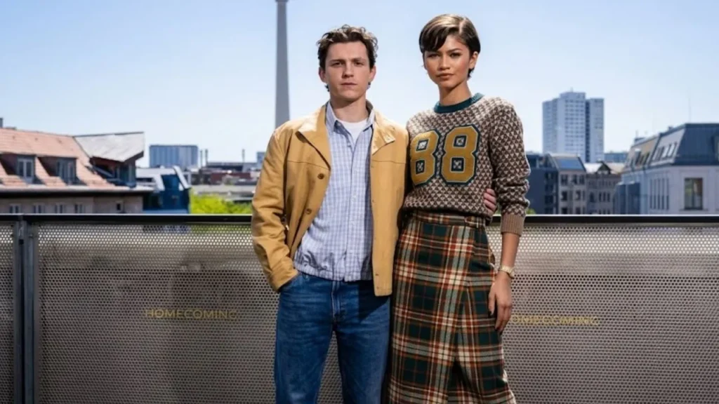 A high-contrast cropped street style photo of Zendaya in a chic retro-glam summer silhouette walking next to Tom Holland in London.
