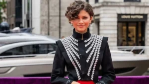 Zendaya wearing a custom web-stitched athletic jersey during a high-profile red carpet press tour.