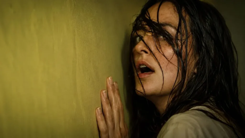 A dark, eerie yellow hallway from A24's Backrooms movie representing the digital release controversy.
