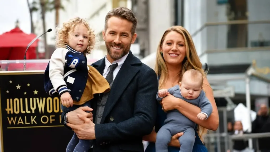 Blake Lively and Ryan Reynolds posing together at an official film premiere event.