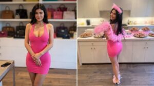 Kylie Jenner smiling next to daughter Stormi Webster during a pink themed birthday celebration