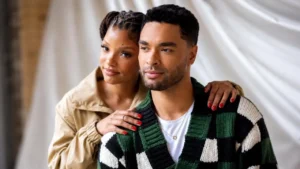 Halle Bailey and Regé-Jean Page standing together in a scenic Tuscan vineyard set.
