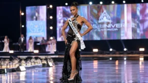 Dr. Gabrielle Henry smiling gracefully in a blue evening gown following her recovery from a pageant fall
