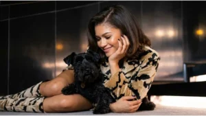 Zendaya smiling on a red carpet wearing an elegant designer outfit