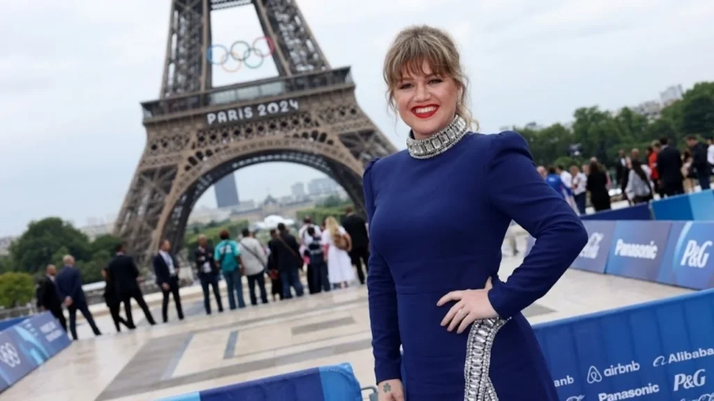 Kelly Clarkson wearing a stylish outfit smiling during a recent television appearance