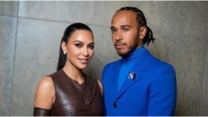 Kim Kardashian posing on red carpet at a media event while discussing her relationship status