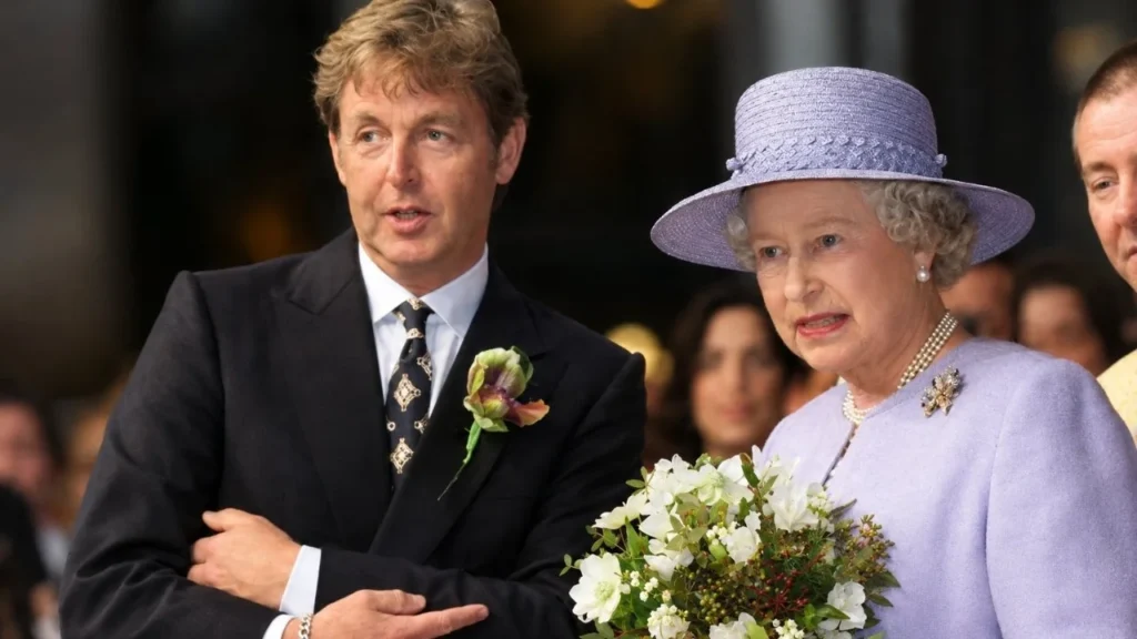 Paul McCartney smiling alongside his wife Nancy Shevell at a red carpet event