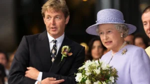 Paul McCartney smiling alongside his wife Nancy Shevell at a red carpet event